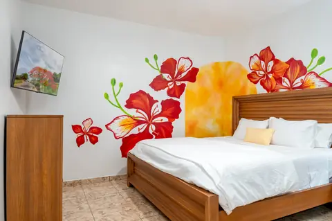 Bedroom with flamboyán flower mural — Casa Paraíso vacation rental in Isabela, Puerto Rico