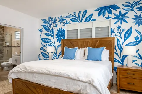 Blue floral bedroom with ensuite bathroom — Casa Paraíso vacation rental in Isabela, Puerto Rico